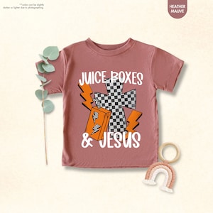 a t - shirt with a cross on it and a pair of scissors next to