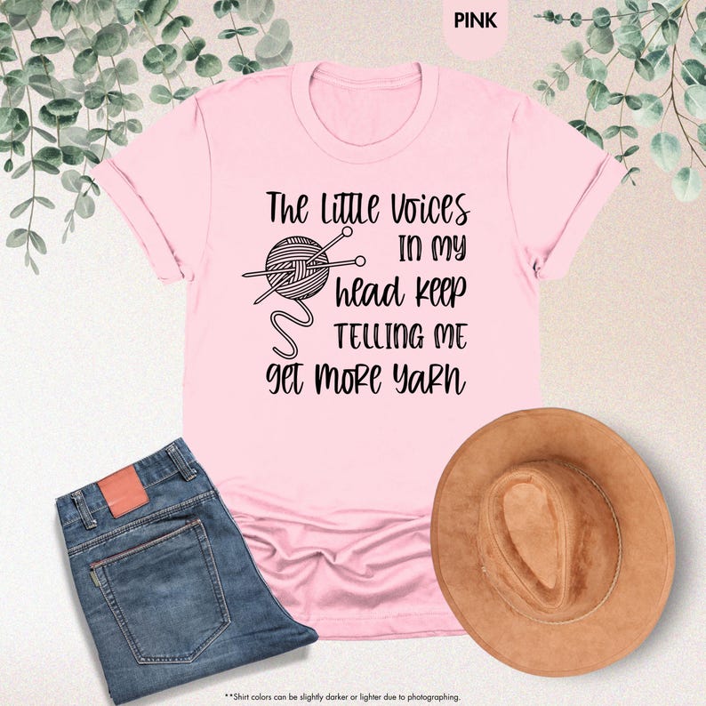 May include: Pink t-shirt with a black graphic of a ball of yarn and knitting needles. The text reads "The Little Voices In My Head Keep Telling Me Get More Yarn".