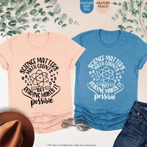three t - shirts and a hat on a table