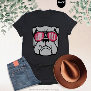 a black shirt with a bulldog wearing sunglasses