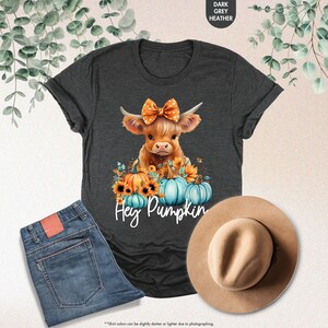 a t - shirt with a cow wearing a bow and pumpkins