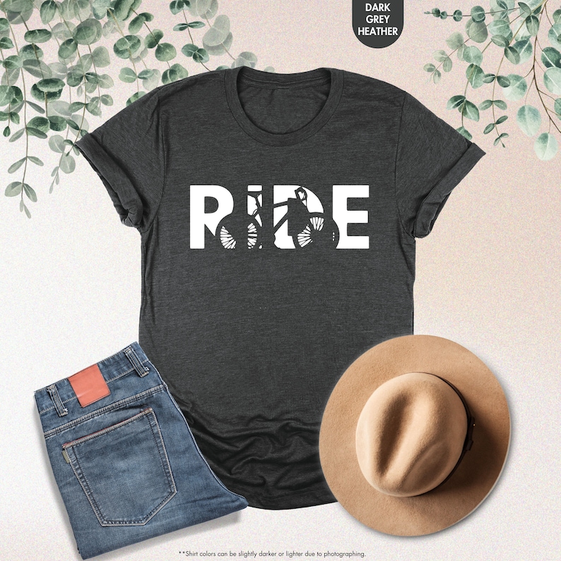 a t - shirt that says ride next to a hat and jeans