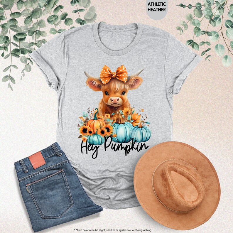 a t - shirt with a cow wearing a bow and pumpkins