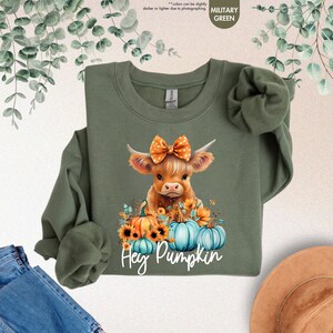 a green shirt with a picture of a cow on it