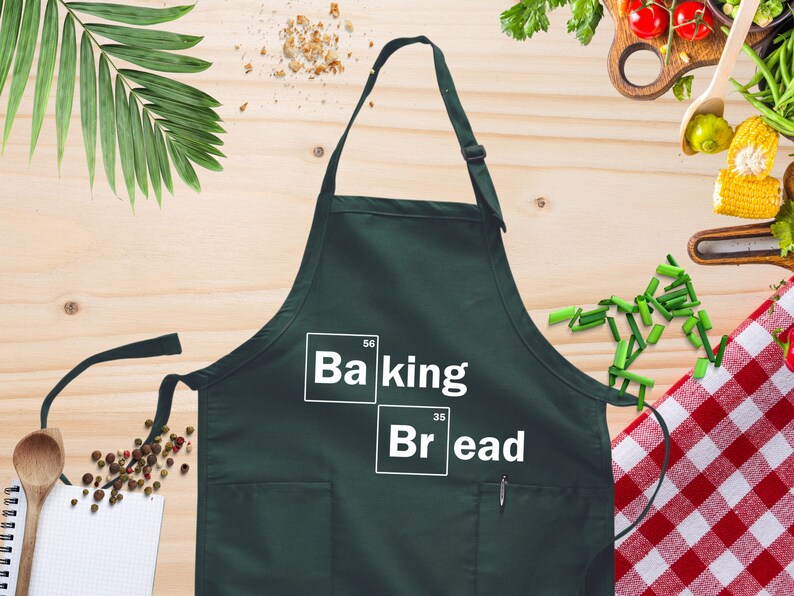 a green apron with the words baking and bread on it