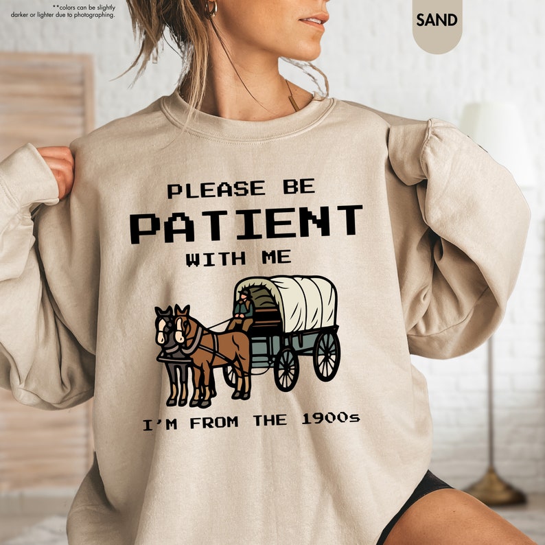 a woman wearing a sweatshirt that says please be patient with me i'm from