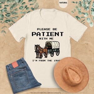 a t - shirt that says please be patient with me i'm from the