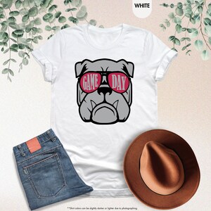 a white shirt with a dog wearing sunglasses