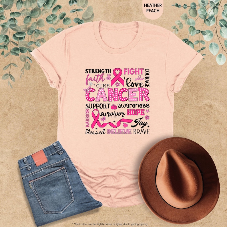 a pink t - shirt with a pink ribbon on it
