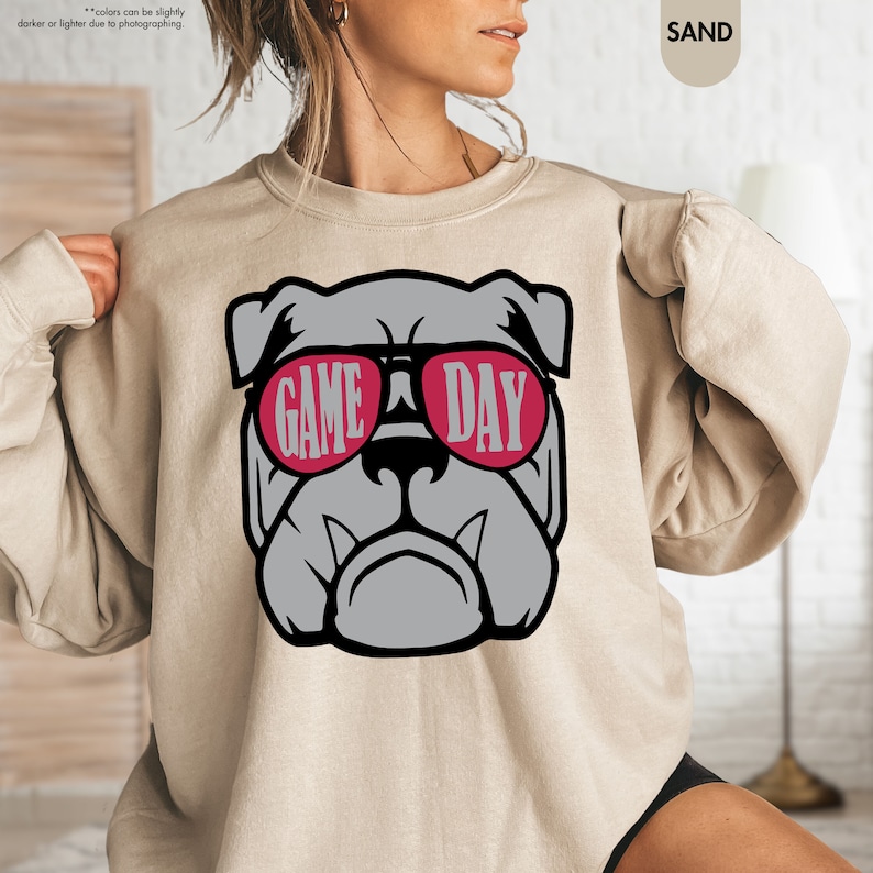 a woman wearing a sweatshirt that says game day