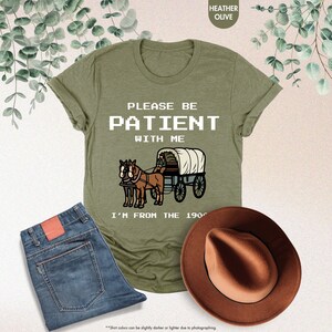 a t - shirt that says please be patient with me i'm from the