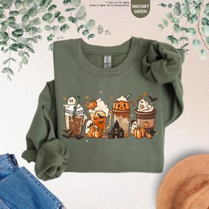 a green shirt with a picture of a group of pumpkins on it
