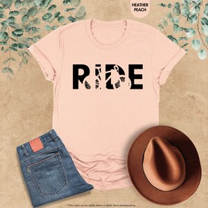 a pink shirt with the word ride on it