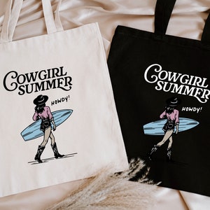 two shopping bags sitting on top of a bed
