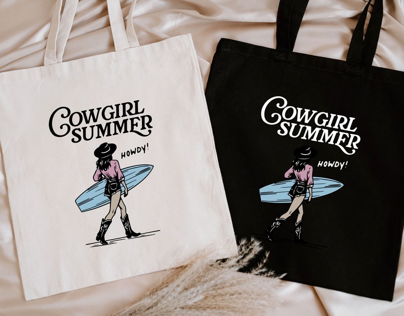 two shopping bags sitting on top of a bed