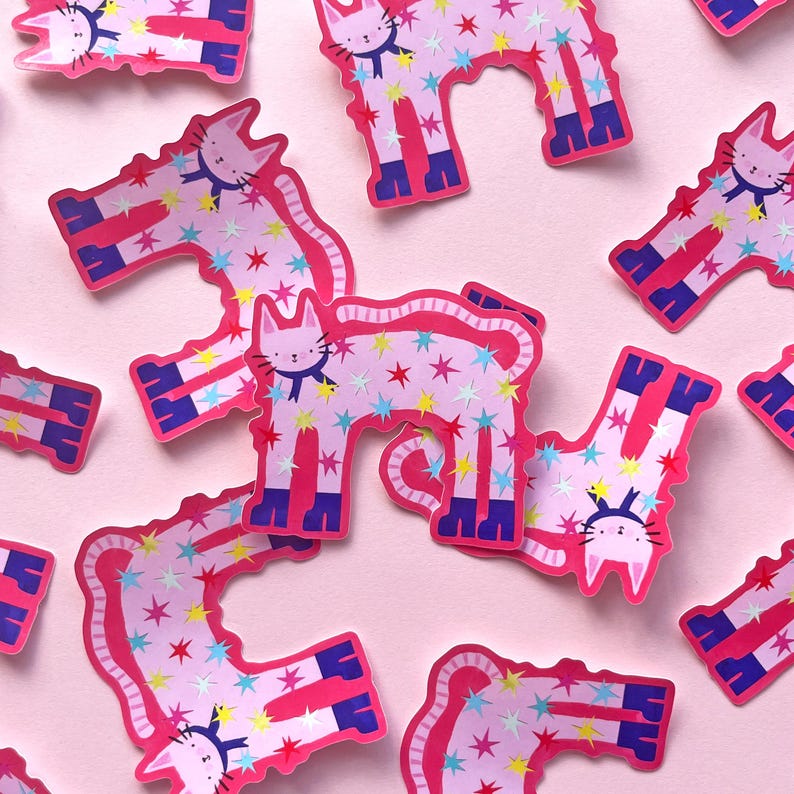 May include: Pink cat stickers with star patterns and blue accents scattered on a pink background. Each sticker features a cat illustration with a bow tie. The stickers are in various orientations.
