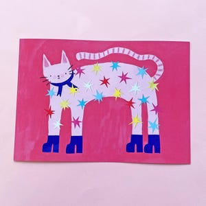 May include: A whimsical illustration of a white cat with a blue scarf and boots, adorned with colorful star cutouts. The cat is set against a vibrant pink background, creating a playful and eye-catching design.