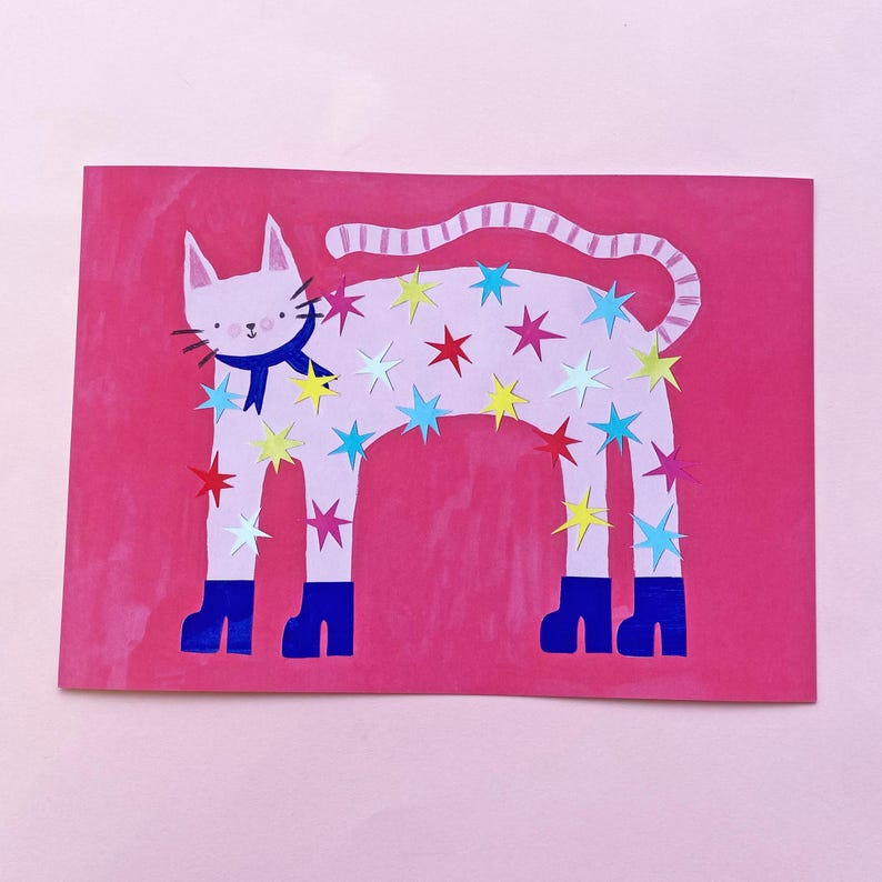 May include: A whimsical illustration of a white cat with a blue scarf and boots, adorned with colorful star cutouts. The cat is set against a vibrant pink background, creating a playful and eye-catching design.
