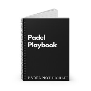 May include: Black spiral bound notebook with white text that reads "Padel Playbook" and "PADEL NOT PICKLE" on the front cover.