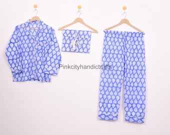 May include: A blue and white patterned pyjama set with a long-sleeved shirt and trousers. The set includes a matching drawstring bag.