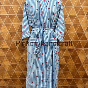 May include: A blue and white striped robe with red heart accents and trim. The robe has a matching belt, pockets, and the text "Pinkcityhandcraft". The robe is displayed on a mannequin.