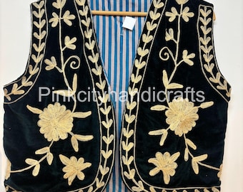 May include: Black velvet vest with gold floral embroidery. The vest features a striped blue and white lining and is displayed on a wooden hanger. The embroidery includes floral and leaf patterns.