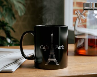 May include: Black ceramic coffee mug with a white graphic of the Eiffel Tower and the text "Cafe Paris".