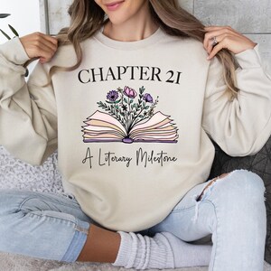 a woman sitting on a couch holding an open book