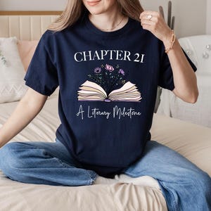 a woman sitting on a bed holding a book