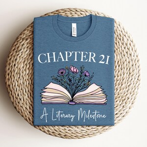 a t - shirt with a book and flowers on it