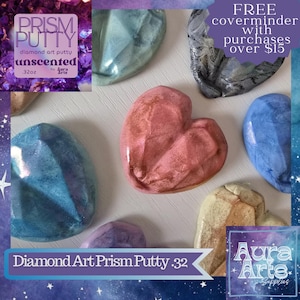 May include: Assortment of diamond art putty in various colors and shapes, including heart and oval designs. The image includes text that reads "PRISM PUTTY" and "Diamond Art Prism Putty .32". The image also includes the text "FREE coverminder with purchases over $15".