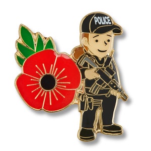 May include: A gold-coloured enamel pin depicting a cartoon police officer holding a rifle. The officer is wearing a black uniform, a black hat with the word "POLICE" on it, and a red poppy.