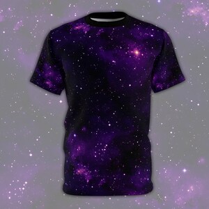 May include: A purple t-shirt with a galaxy print. The shirt is covered in small white stars and a large purple nebula.