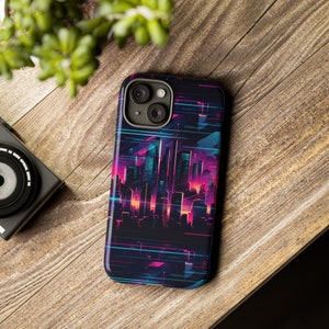 May include: A black smartphone case featuring a vibrant cityscape design in shades of pink, purple, and teal. The case has a glossy finish and a sleek, modern aesthetic. The design includes stylized skyscrapers and neon-like lines.