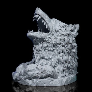 May include: A gray wolf head sculpture with an open mouth, revealing sharp teeth. The sculpture has detailed fur and sits on a rocky base. The background is black.