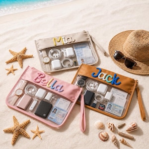 May include: Three rectangular zippered pouches with clear fronts and wrist straps, personalized with embroidered names Mia, Bella, and Jack. Each pouch contains electronic accessories, charging cables, watches, and identification cards.