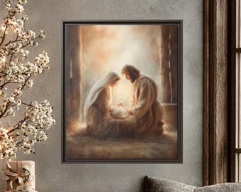 May include: A framed artwork depicting a religious scene with soft lighting. The image shows two figures kneeling over a baby. The scene is set in a warm, neutral color palette. The artwork is displayed above a wooden ledge with gifts, pillows, and a lit candle.