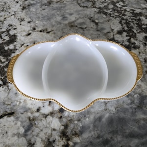 Vintage Anchor Hocking Fire King milk glass divided relish tray with gold trim.