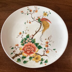 Handgeschilderd verzamelbord met bloemen en een vogel