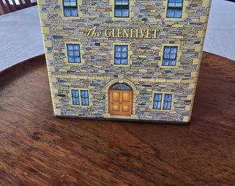 The highlighted item is a vintage decorative house tin from The Glenlivet, manufactured in England exclusively as promotional merchandise