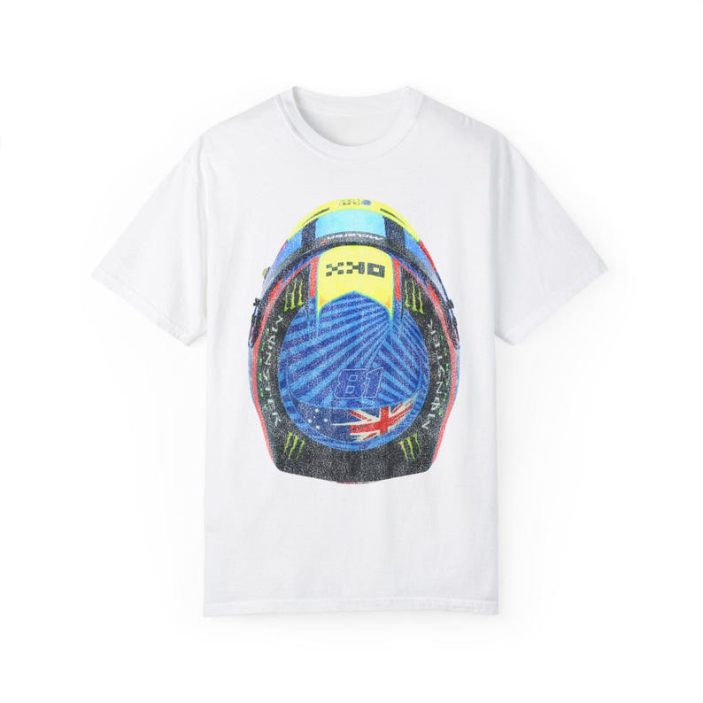 May include: White t-shirt with a graphic print of a blue, yellow, red, and green motorcycle helmet. The helmet has a white and blue Australian flag on the side.