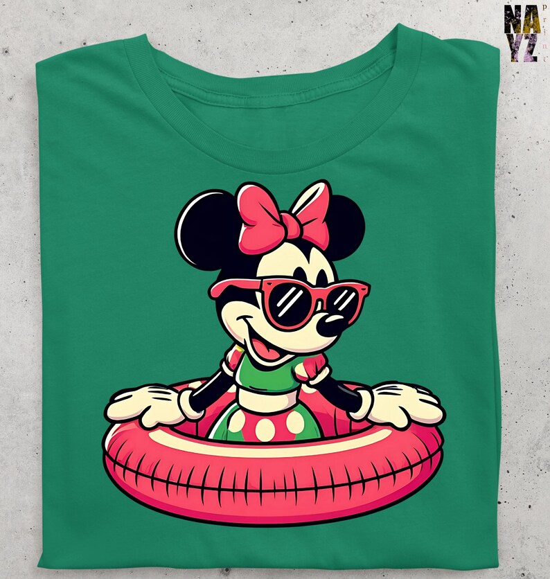 May include: Green t-shirt with a cartoon character wearing sunglasses and a pink bow. The character is in a red and pink inner tube. The character is wearing a green top and a polka dot skirt. The shirt has a crew neck.
