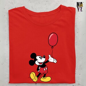May include: Red t-shirt with a cartoon image of Mickey Mouse holding a red balloon.