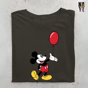 May include: A dark green t-shirt with a cartoon image of Mickey Mouse holding a red balloon. Mickey Mouse is wearing his signature red shorts and yellow shoes.