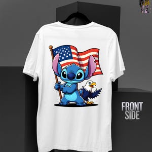 May include: White t-shirt featuring a cartoon character holding an American flag, with an eagle on the right. The character is blue with large ears. The flag has red and white stripes and a blue field with white stars. The words "FRONT SIDE" are printed on the right.
