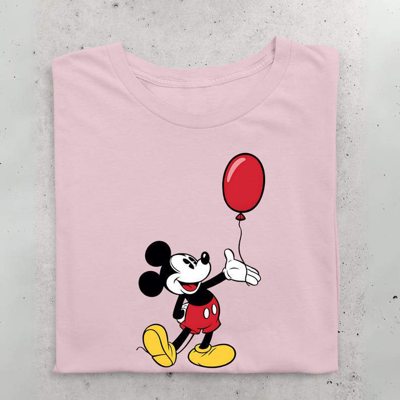 May include: A pink t-shirt with a cartoon image of Mickey Mouse holding a red balloon. Mickey Mouse is wearing his signature red shorts and yellow shoes.