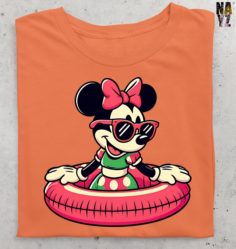 May include: Orange t-shirt with a cartoon Minnie Mouse design. Minnie is wearing sunglasses and a pink bow, and is in a pink and white inflatable ring. She is wearing a green and white polka dot dress. The shirt is folded.