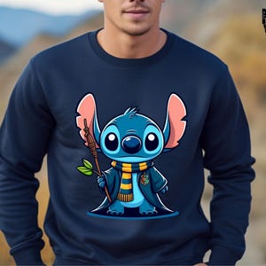 May include: A navy blue sweatshirt with a cartoon image of Stitch from Lilo & Stitch dressed as a wizard. Stitch is holding a wand and wearing a yellow and blue scarf.