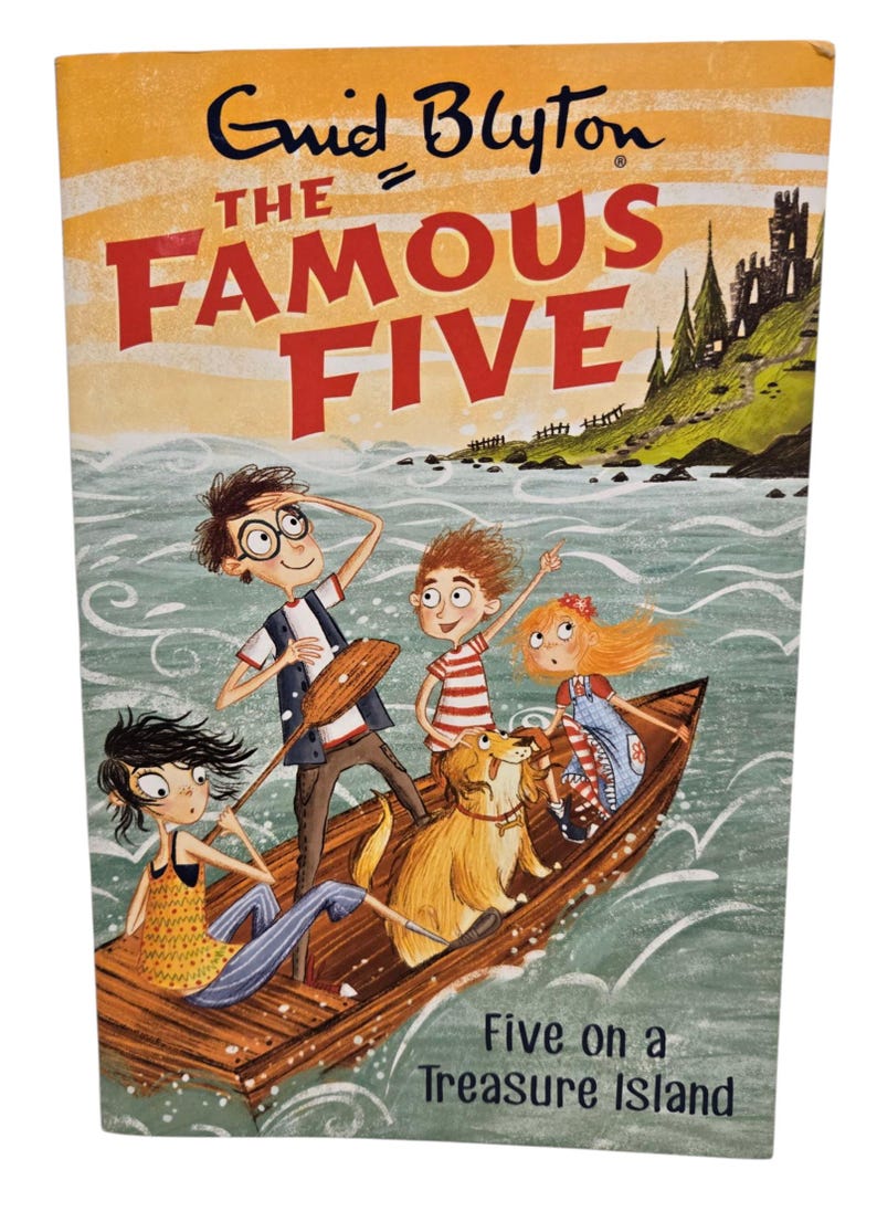 May include: A book cover for "The Famous Five: Five on a Treasure Island" by Enid Blyton. The cover features an illustration of five children and a dog in a boat on water, with a castle in the background. The title is in large red letters.