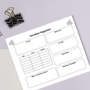 May include: A white paper planner titled "Overflow Organizer" with sections for to-do lists, research, and meal planning. Includes a black and white patterned paper clip.